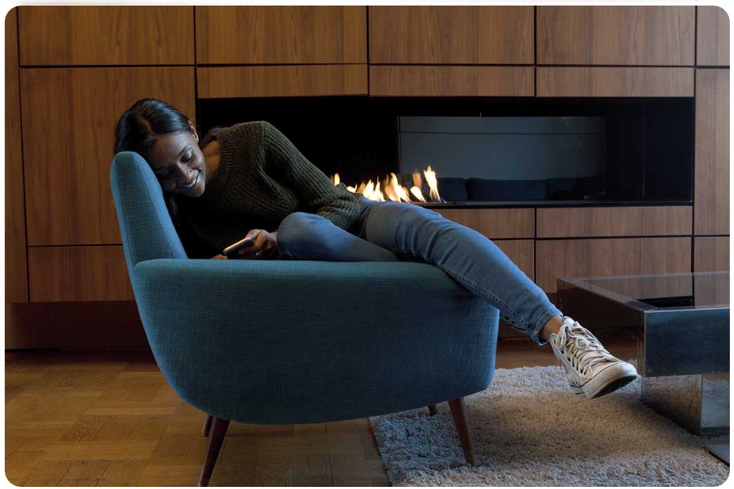 Woman relaxing in chair while looking at phone