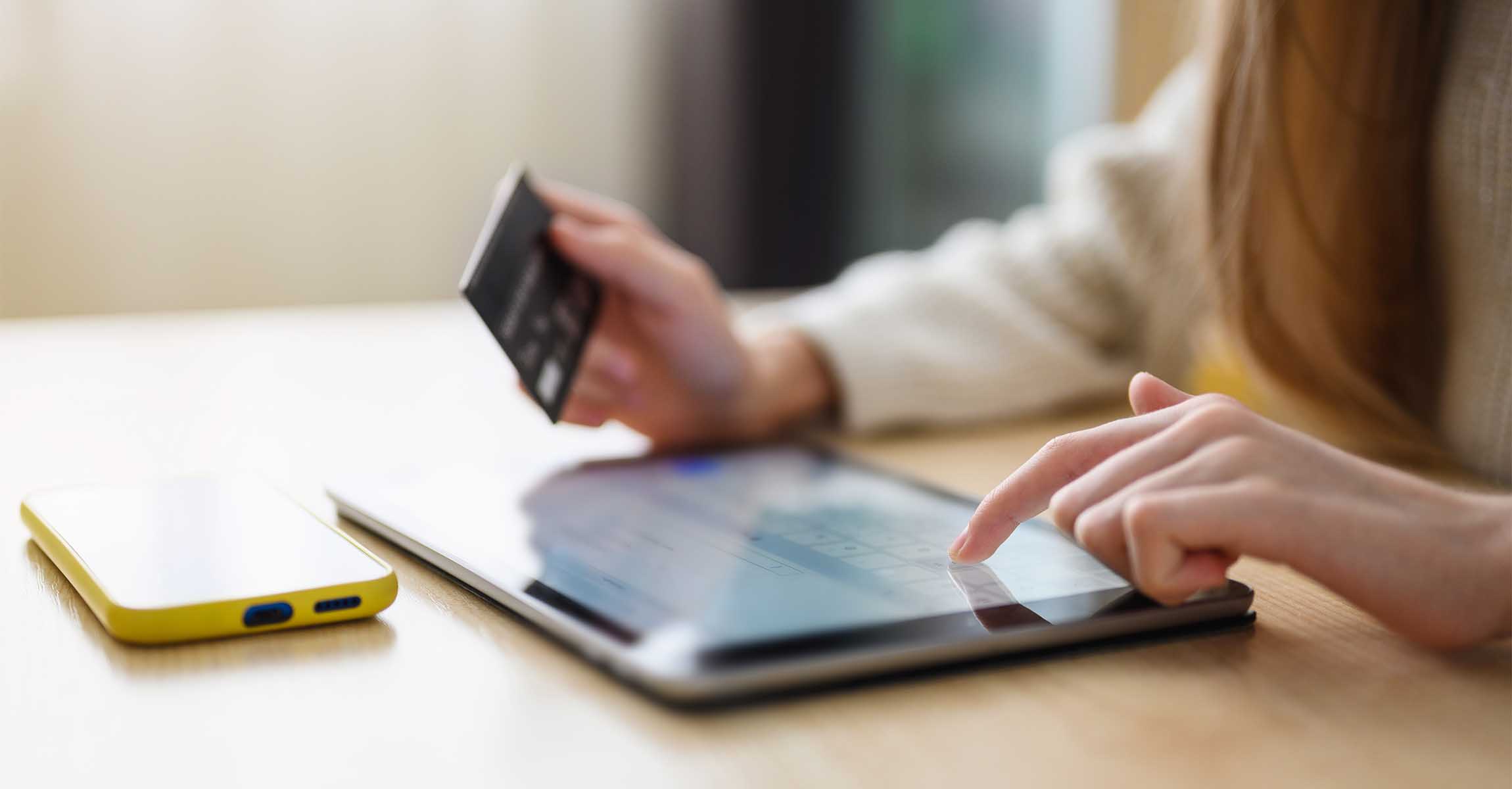 Person using credit card via tablet device