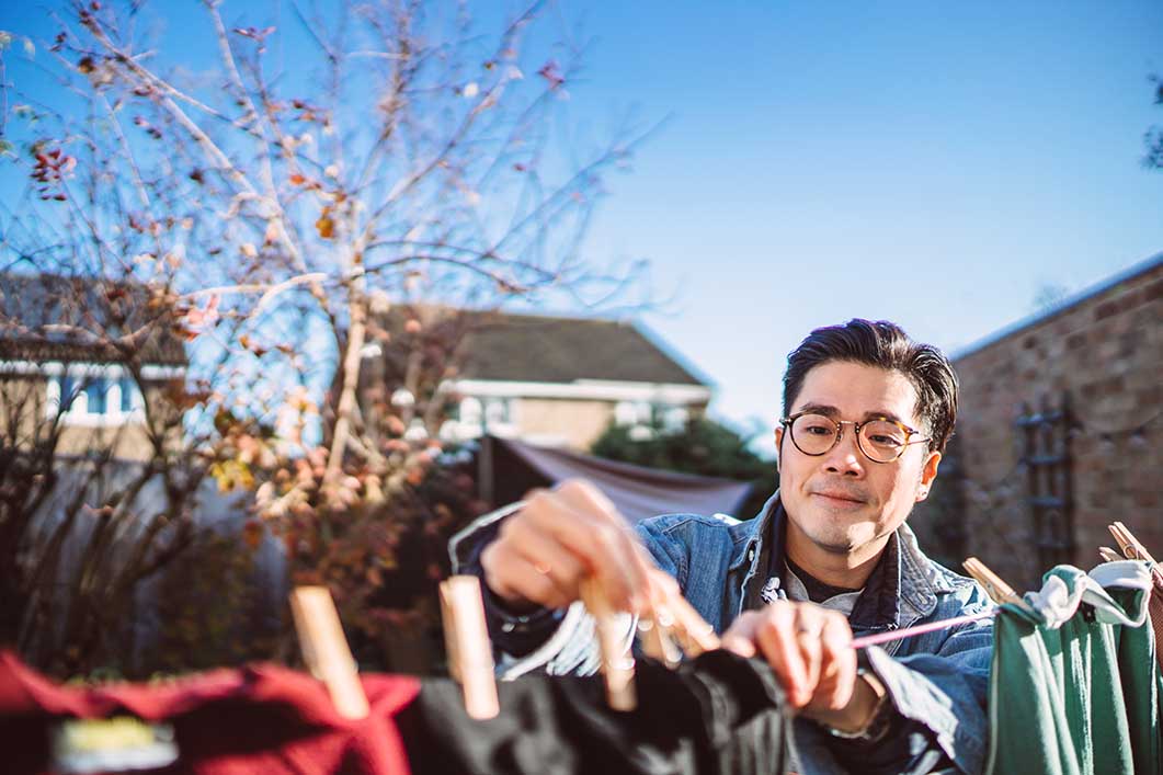 Man hanging up clothes washing